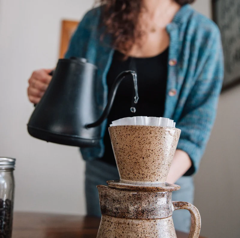Coffee poured into a handmade ceramic dripper