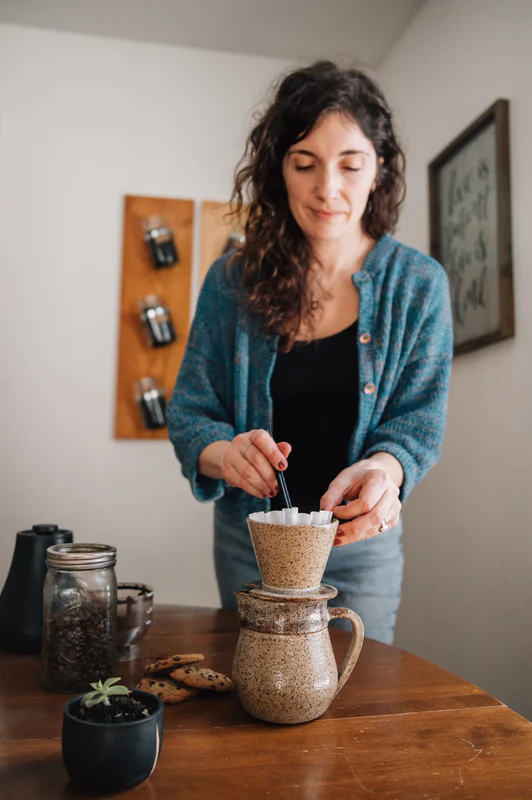 Preparing coffee with handmade Wildflower pottery