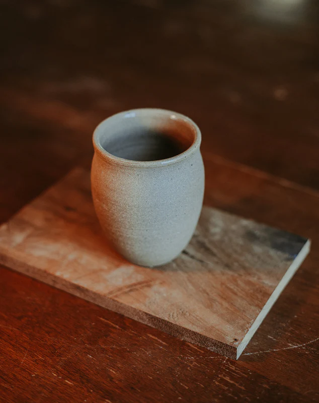 Handmade cup on a wooden board